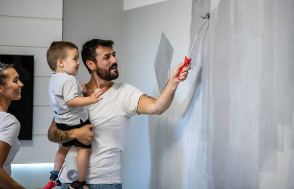 Family repainting walls, using a roller, with the old paint not quite matching the new color at Triboro Paint near North Attleborough, MA